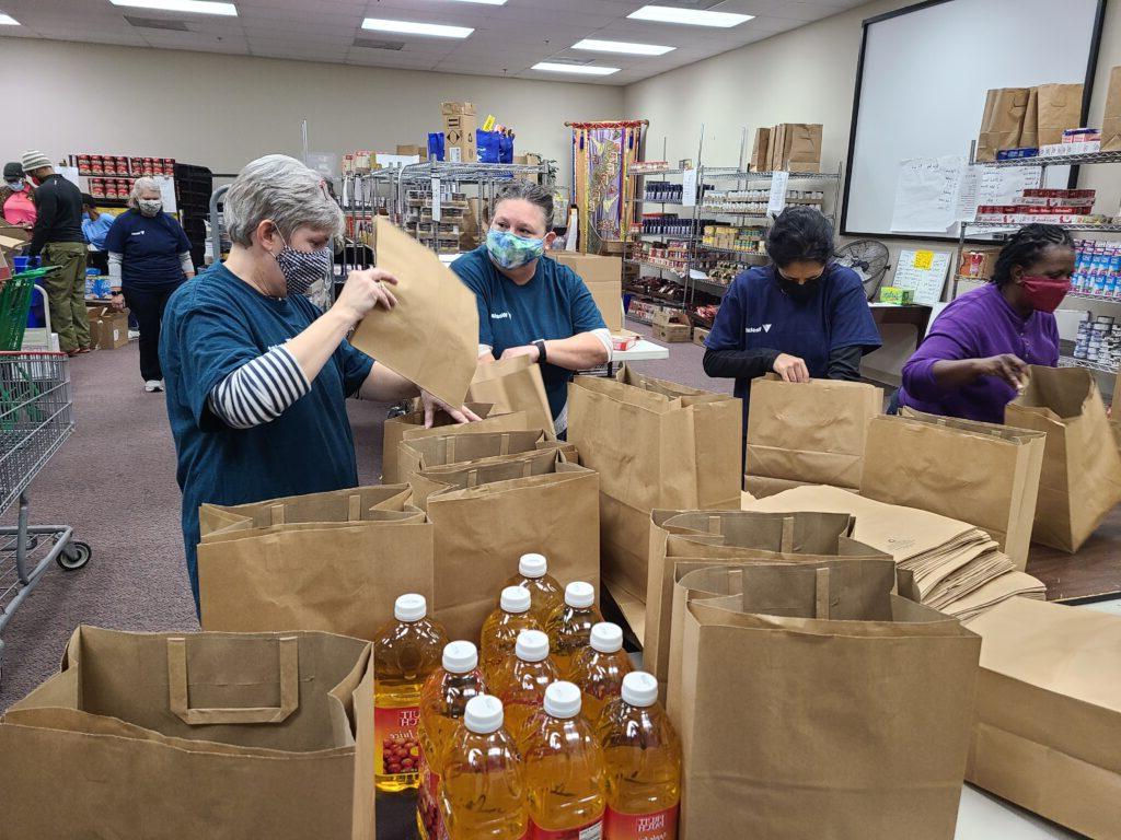 Women packing boxes with food items